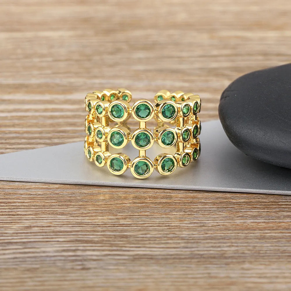 Copper ring with 18K gold plating and green zircon stones in exaggerated wide-band design