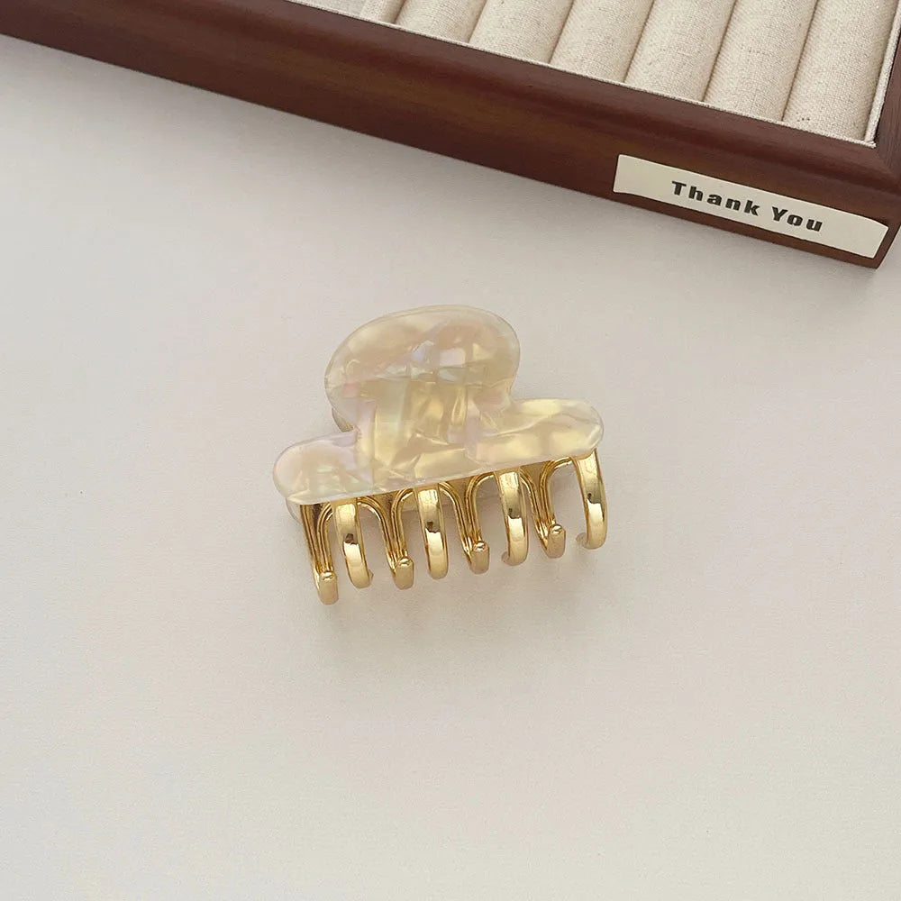 Women's retro acetate hair barrette with metal alloy grip in creamy-white, fairy white, ink colour, and leopard print variations