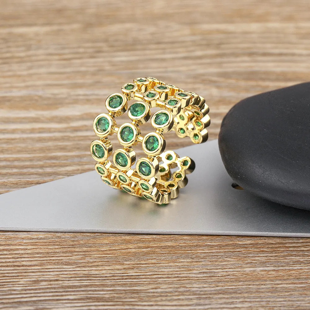 Copper ring with 18K gold plating and green zircon stones in exaggerated wide-band design