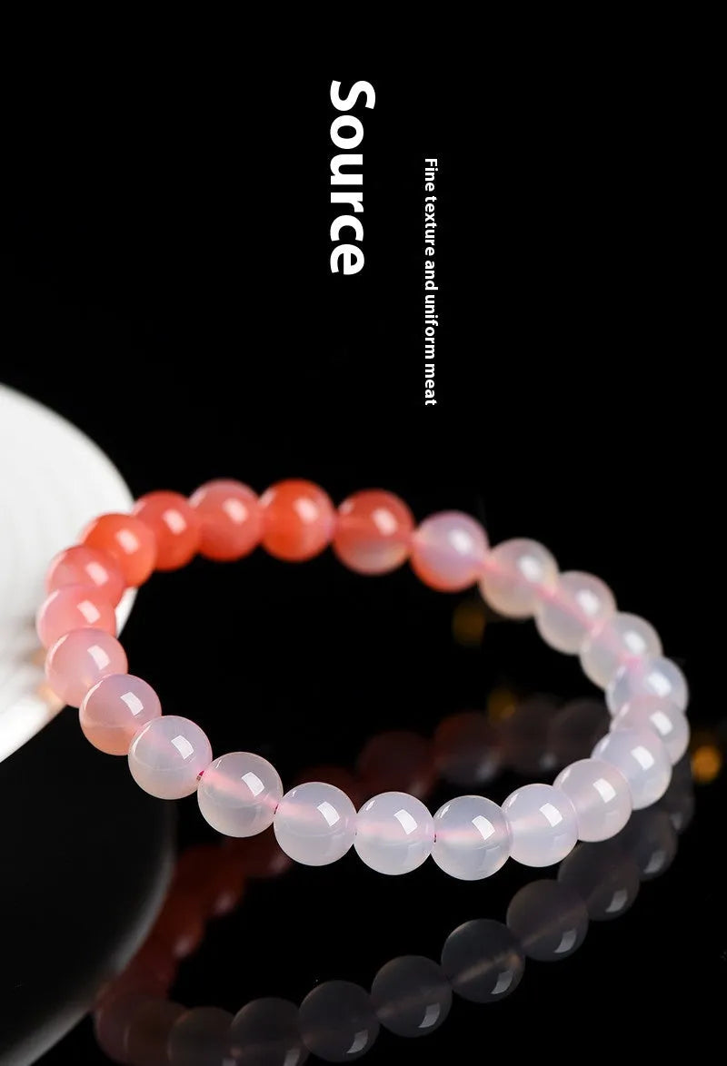 Natural gradient Yanyuan agate bracelet with geometric beads on a wrist, showing salt source colour variation.