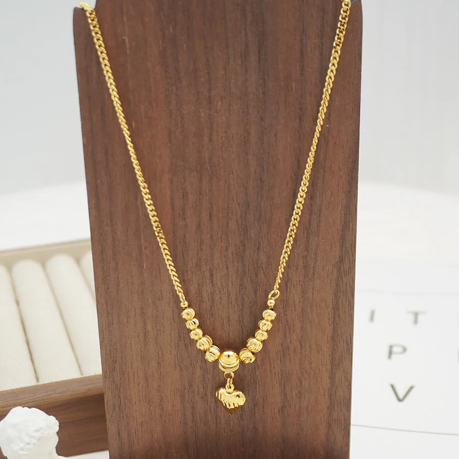 Copper heart necklace with electroplated finish, geometric shape, on white background
