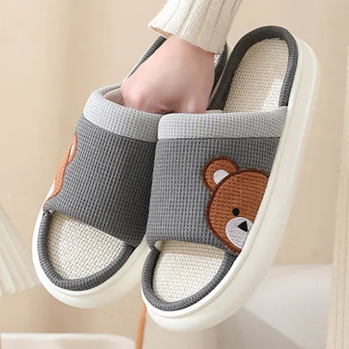 Pair of women's cartoon bear slippers with cotton linen upper and non-slip PVC sole, in light brown colour