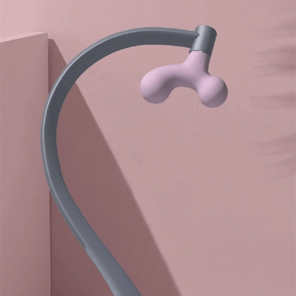 Light purple plastic scapula seam massager hook on a neutral surface