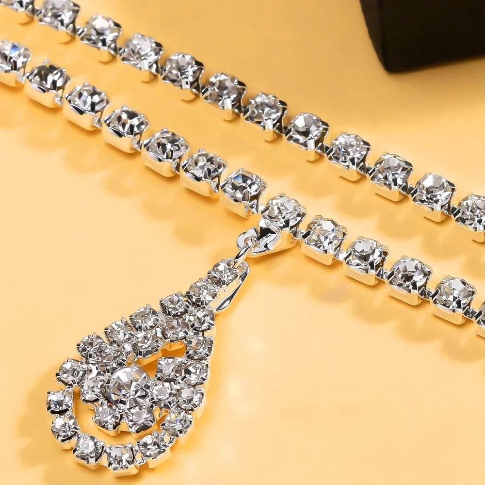 Gold rhinestone water drop pendant on a 115cm adjustable waist chain with lobster buckle.