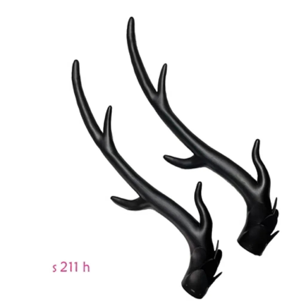 A pair of black resin dragon horn decorations for motorcycle helmet customisation, showing curved shape and mounting base.