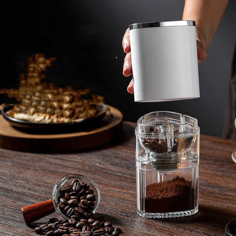 White and black portable electric coffee grinder with ceramic burr and USB charging cable.