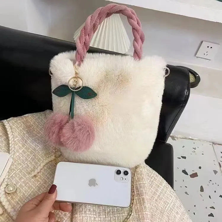 Large capacity soft plush bucket bag in beige with open outer pocket and single shoulder strap