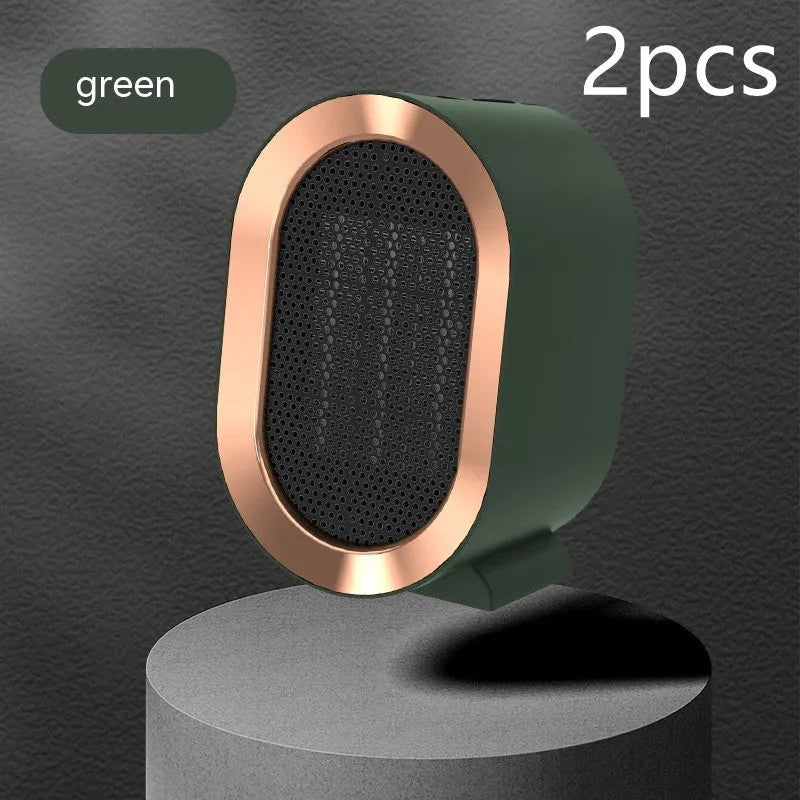 Compact desktop ceramic fan heater in black on a wooden desk.