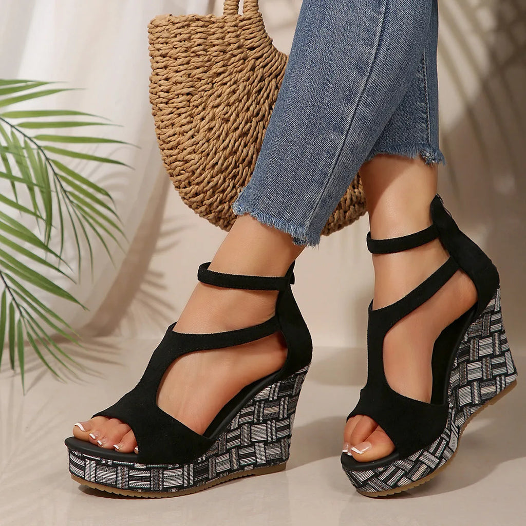 Women's beige ankle-strap sandals with a buckle and thick, textured rubber soles on a plain background.
