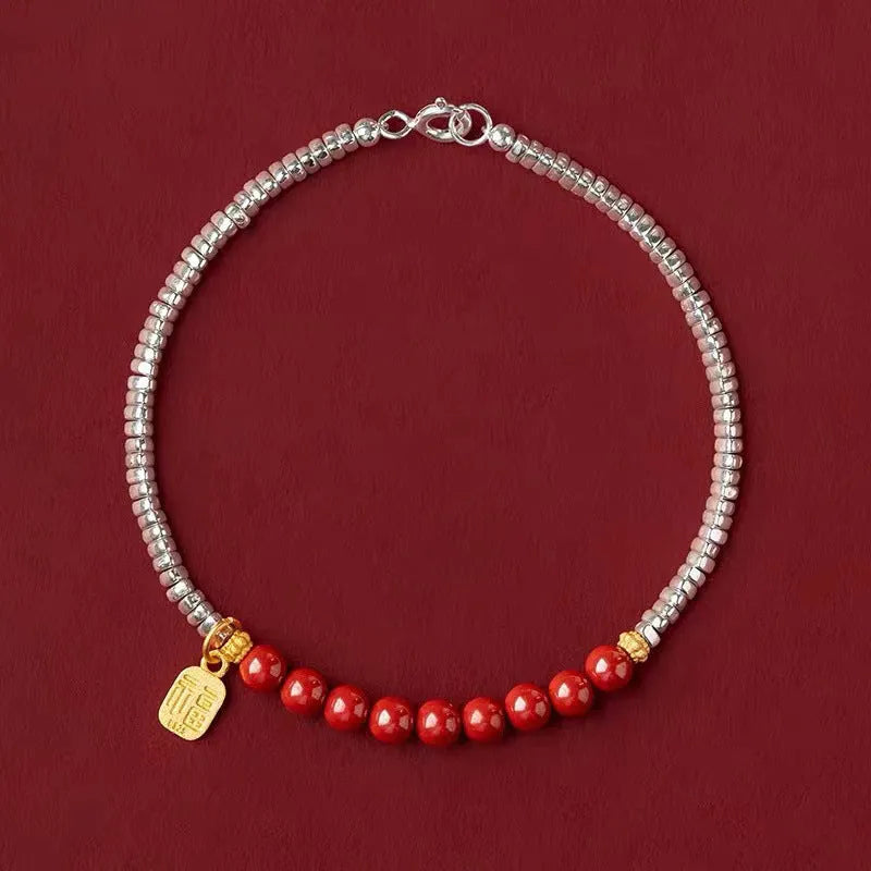 Silver-toned couple bracelet with geometric charm and round beads on white background