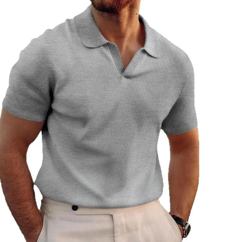Man wearing a slim fit black heavy waffle knit t-shirt with short sleeves.