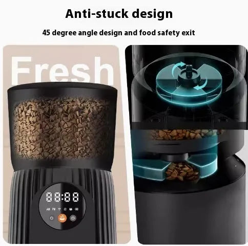 Black automatic pet feeder with digital display and food hopper on a wooden floor.