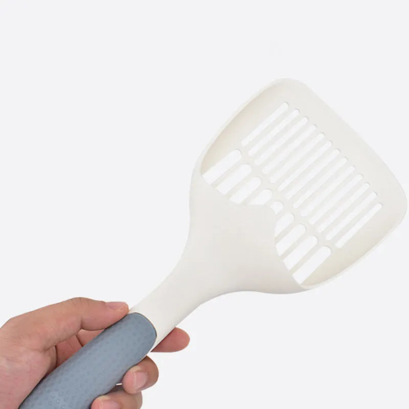 Large white plastic cat litter scoop with a deep bowl and multiple drainage holes.