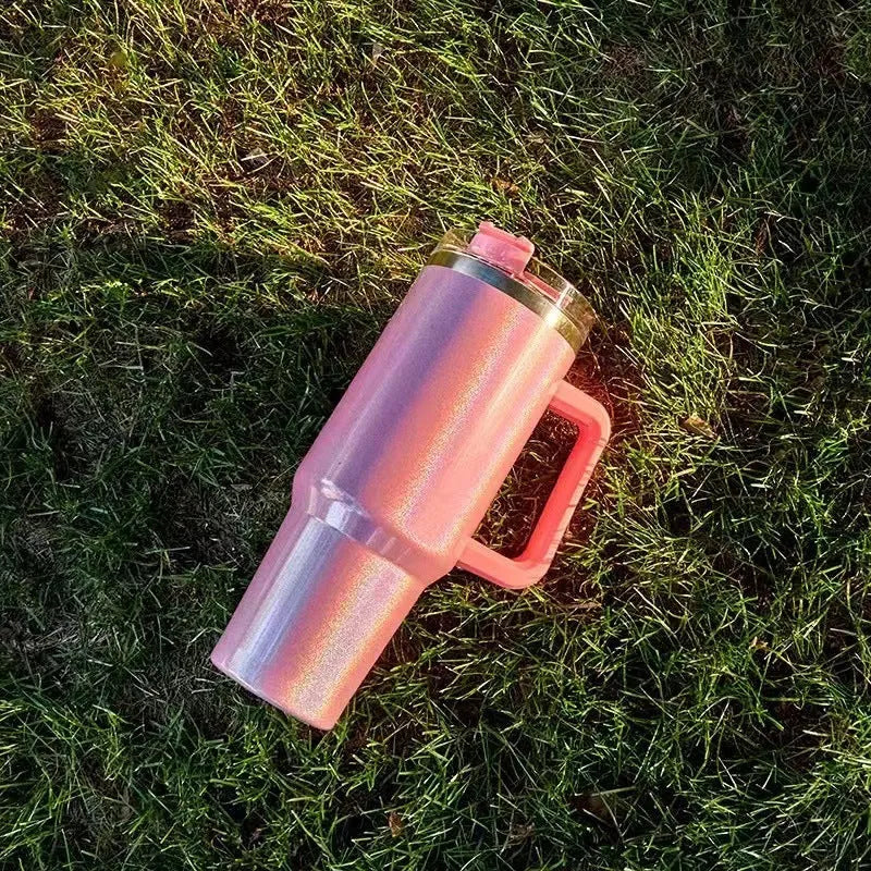 Large stainless steel vacuum insulation cup showing rainbow colour options and gradient designs
