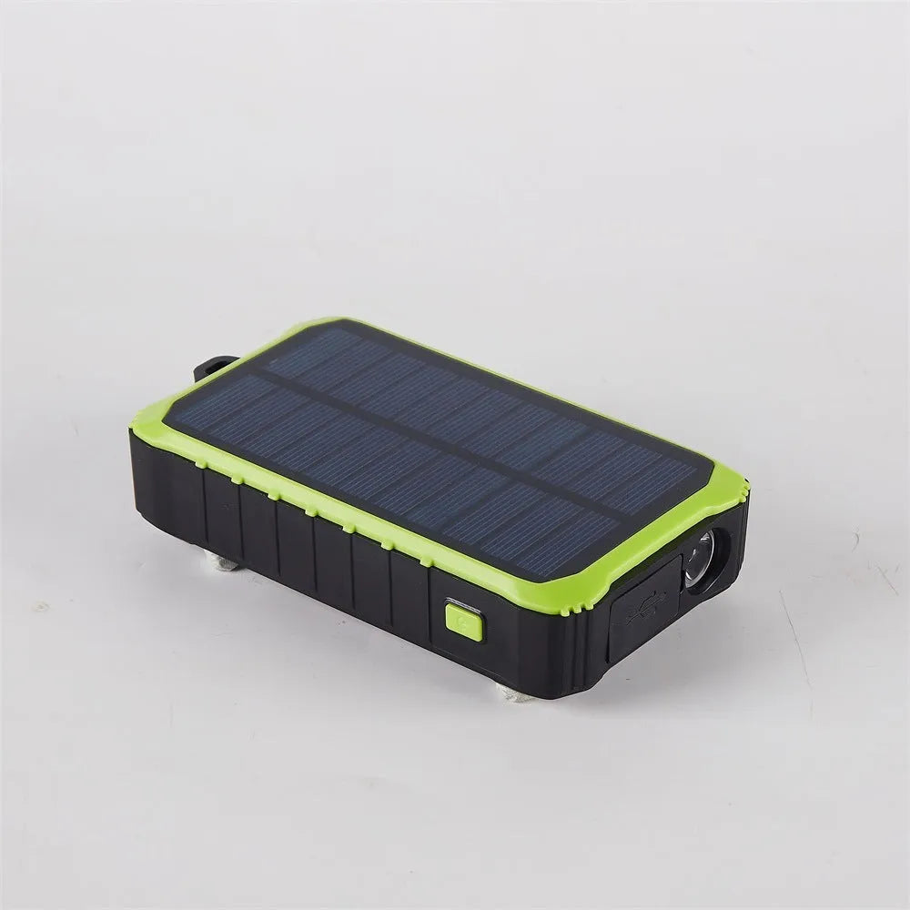 Green and orange hand solar power bank with solar panel, hand crank, and dual USB ports.