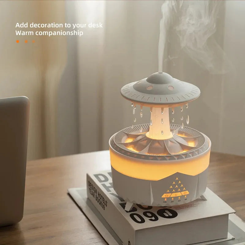 White UFO-shaped cloud humidifier with mist and soft blue night light on a wooden table