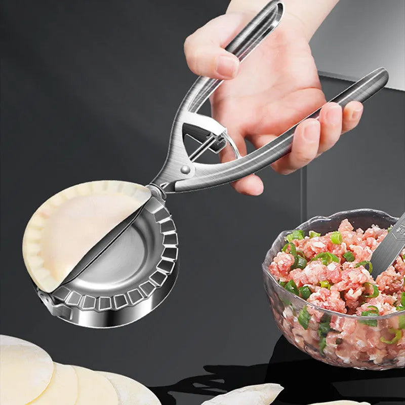 Silver stainless steel manual dumpling press tool on kitchen work surface