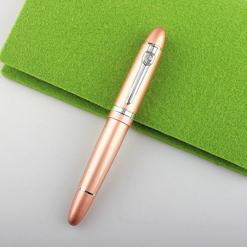 Metal ball pen with pearl beads, black body and silver clip, lying on a desk
