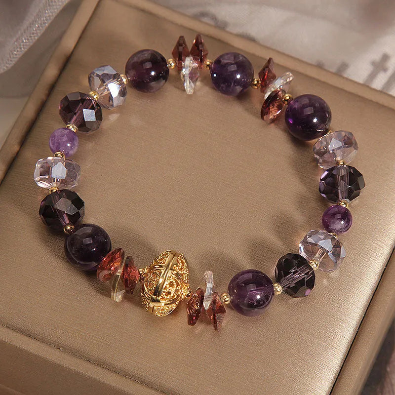 Purple crystal bracelet with pumpkin-shaped beads and rhinestone accents on a wrist.