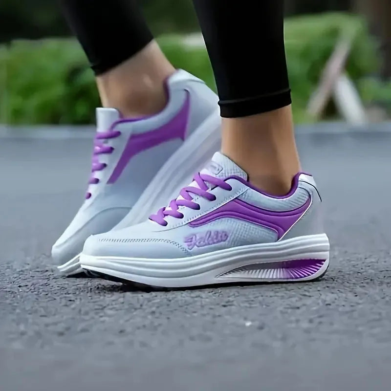 Women's low-heel sports shoe in a choice of colours including black, blue, pink, and purple.