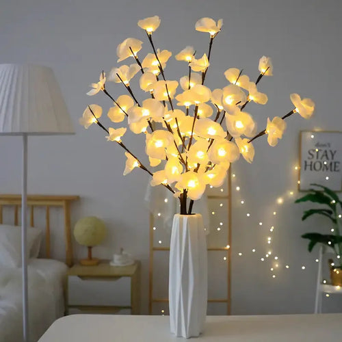 A 65cm tall pink LED phalaenopsis orchid branch light with fabric petals, powered by batteries.