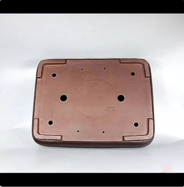 Handmade large rectangular purple clay flower pot for floor plants on a table.