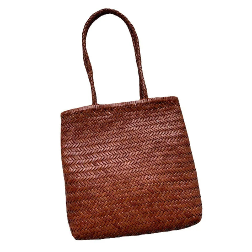 Brown handmade woven cowhide leather tote bag with a three-dimensional outer pocket.