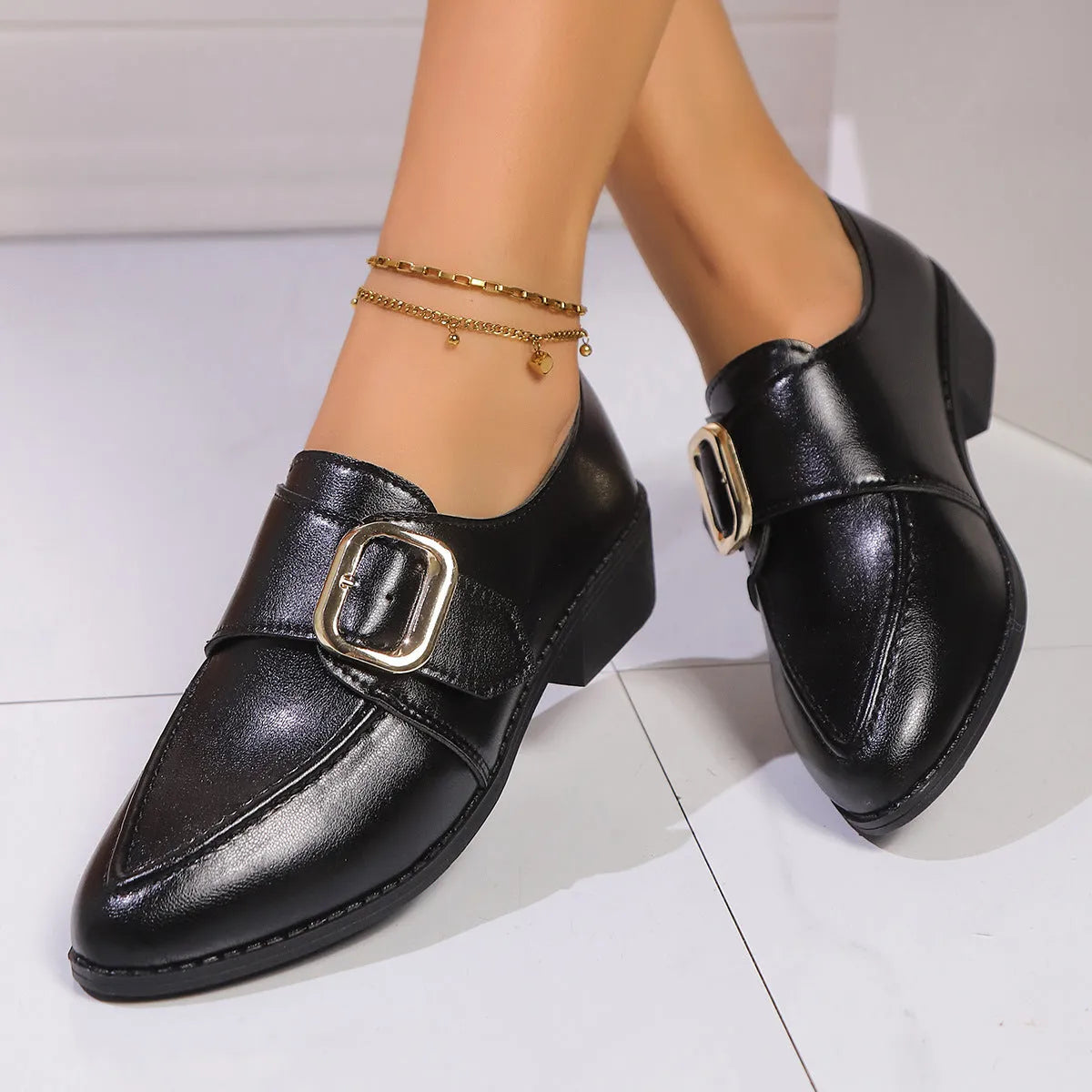 Women's simple leather-look shoes with a decorative bow, on a rubber sole.