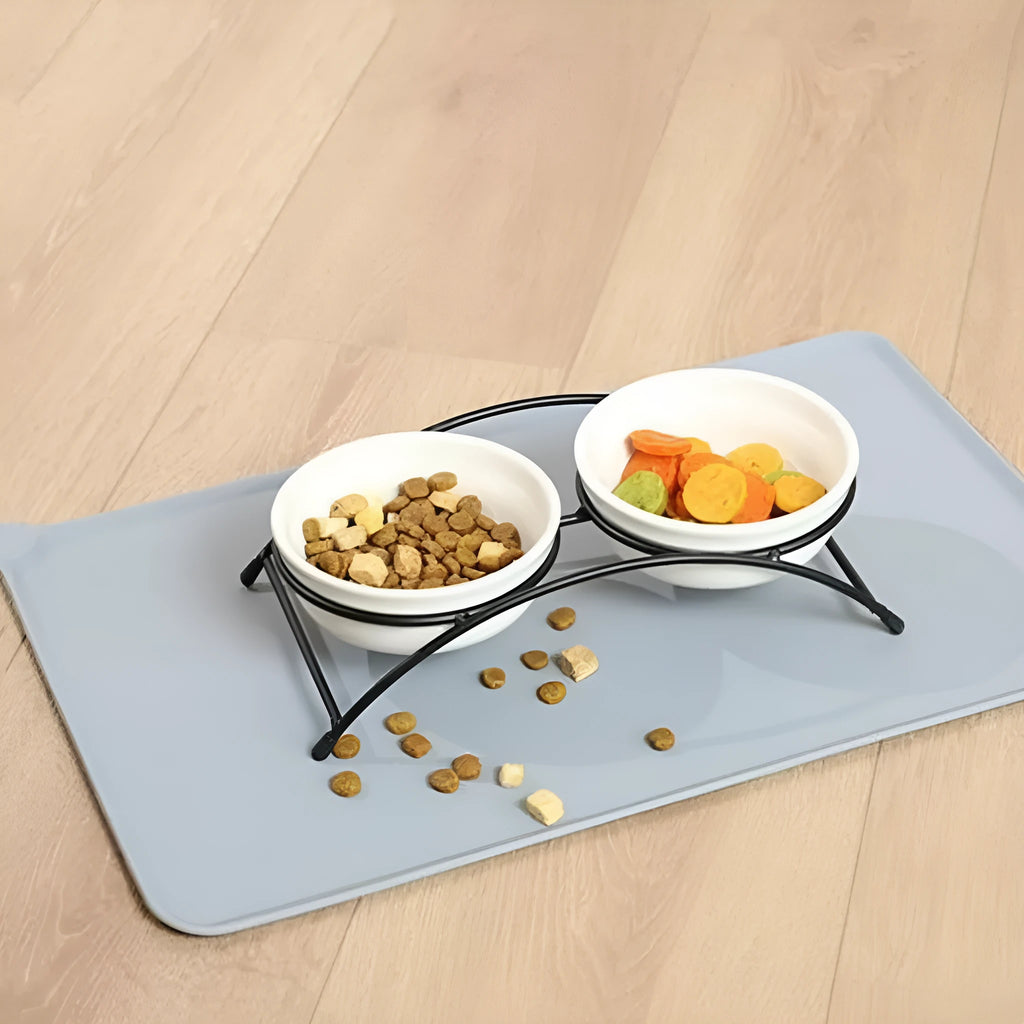 Silicone pet food placemat in blue colour with a raised lip, showing a dog bowl placed on it.