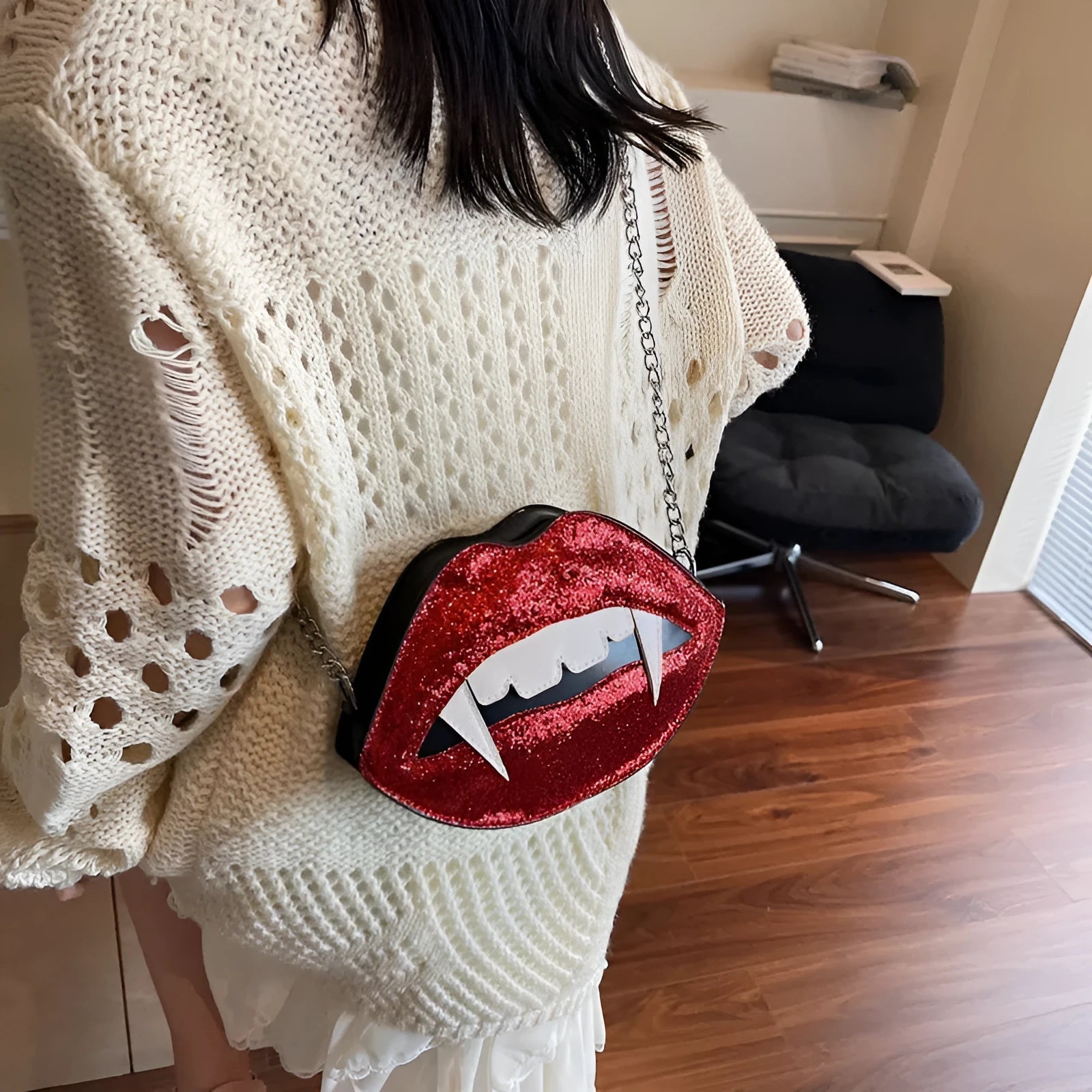 Small red PU sequin crossbody bag with chain detail, oval hard shape, front view on plain background