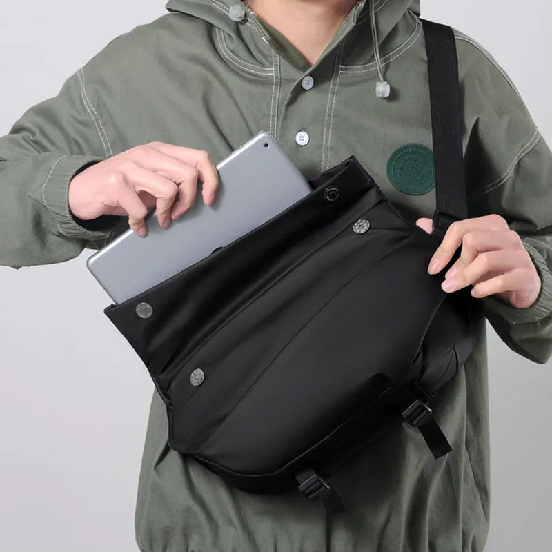 Grey men's PU leather crossbody bag showing front zipper and adjustable strap.