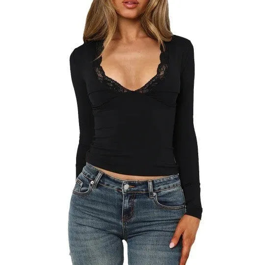 Women's black slim-fit long sleeve top with white lace flower decoration on the front.