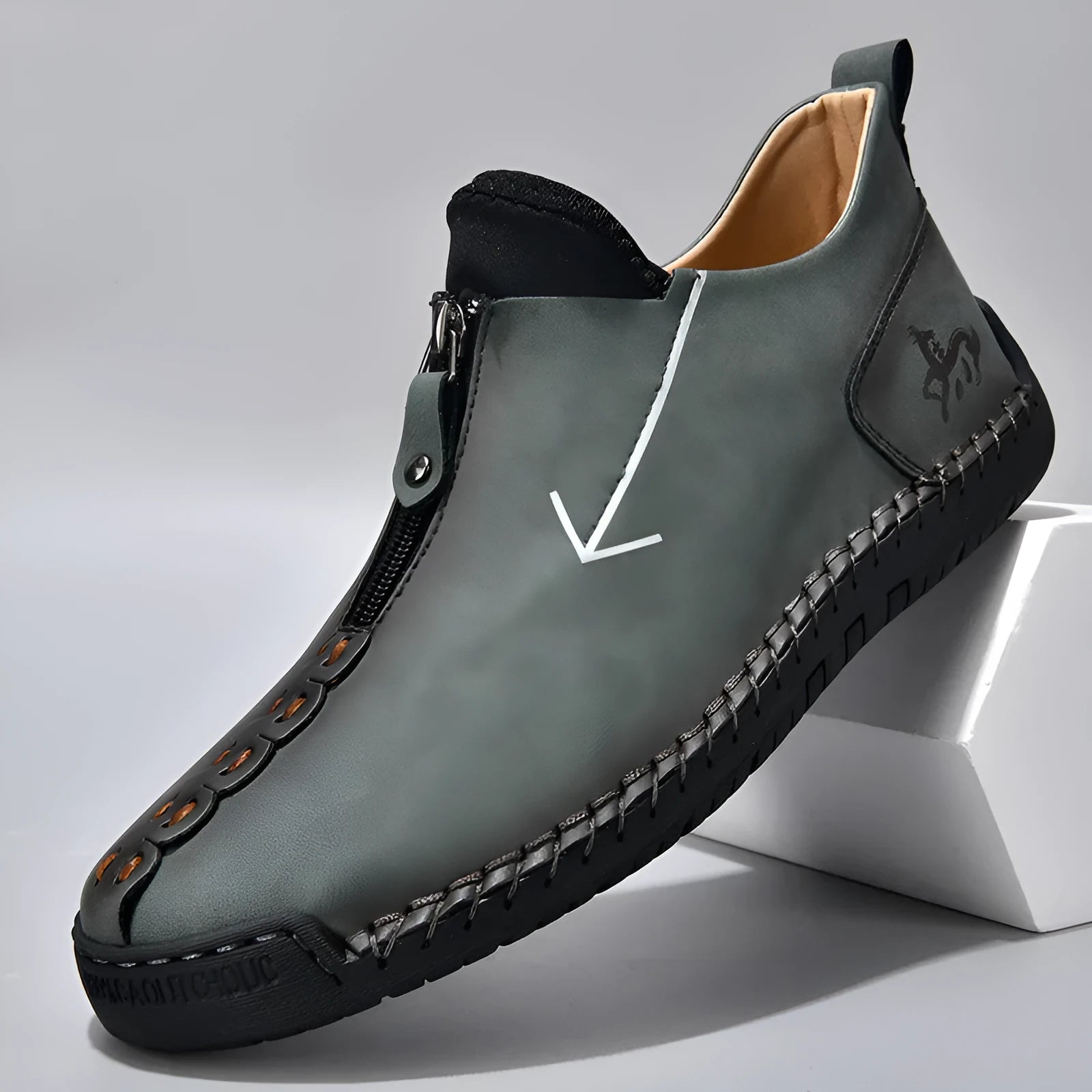 Men's black leather ankle boots with a front zip and round toe on a rubber sole