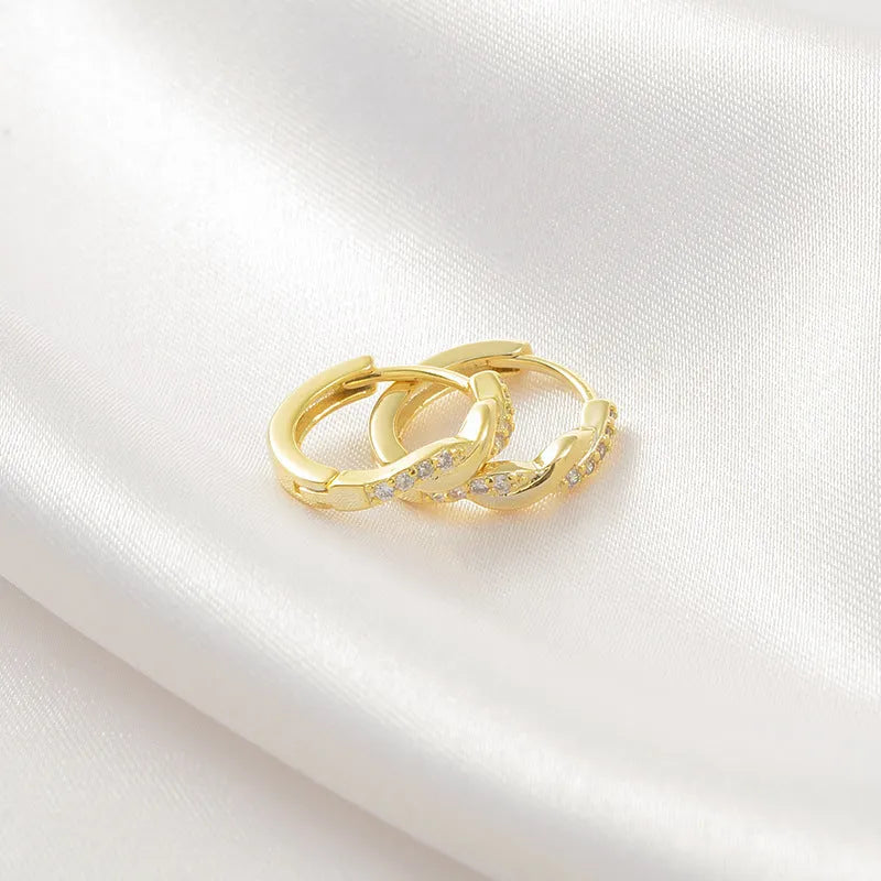 Gold geometric interwoven hemp rope earclip earrings on a white background