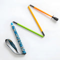 Ultralight high modulus carbon fibre five-section folding trekking pole in colourful finish against outdoor background