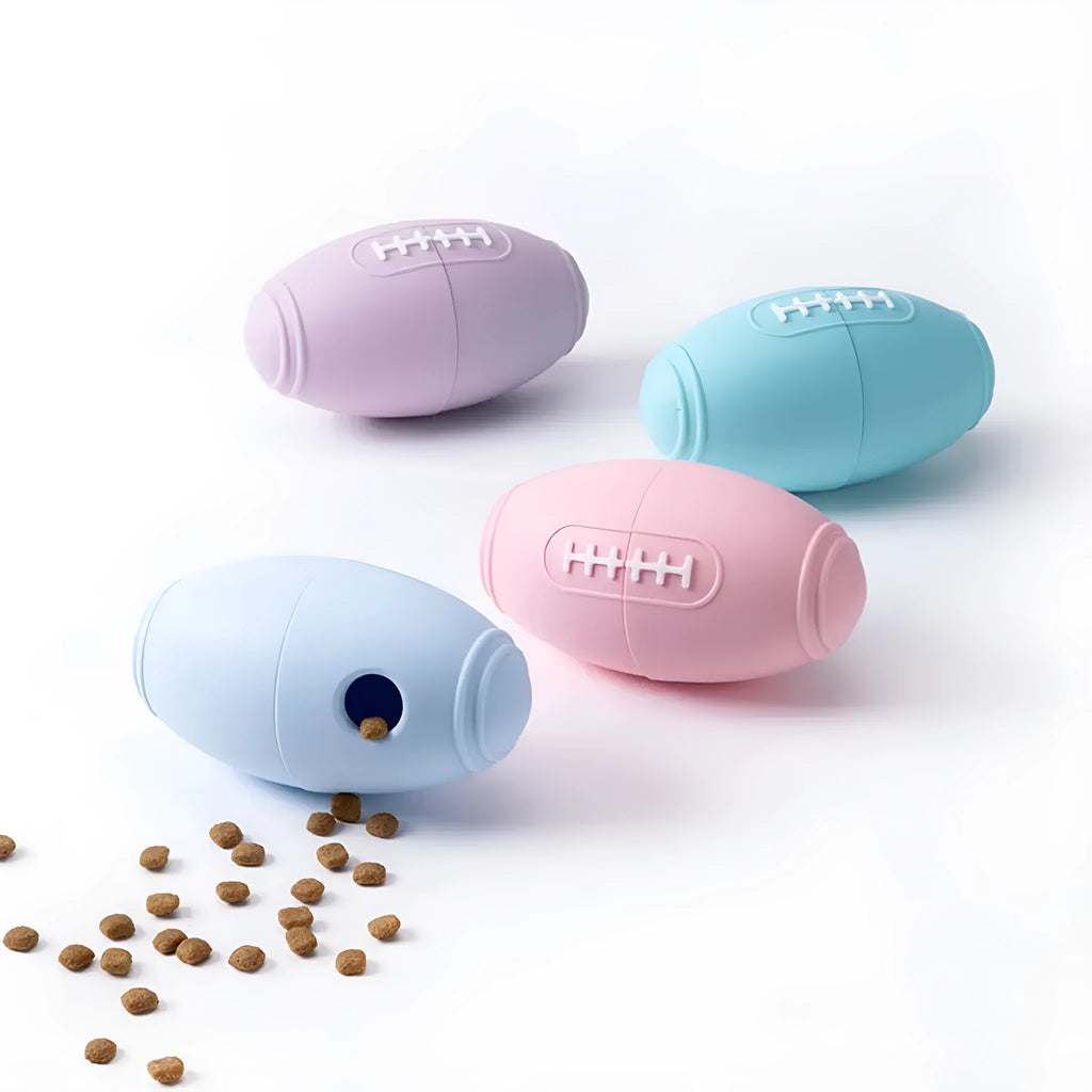 Blue silicone rugby ball shaped dog chew toy for boredom relief and interactive feeding.