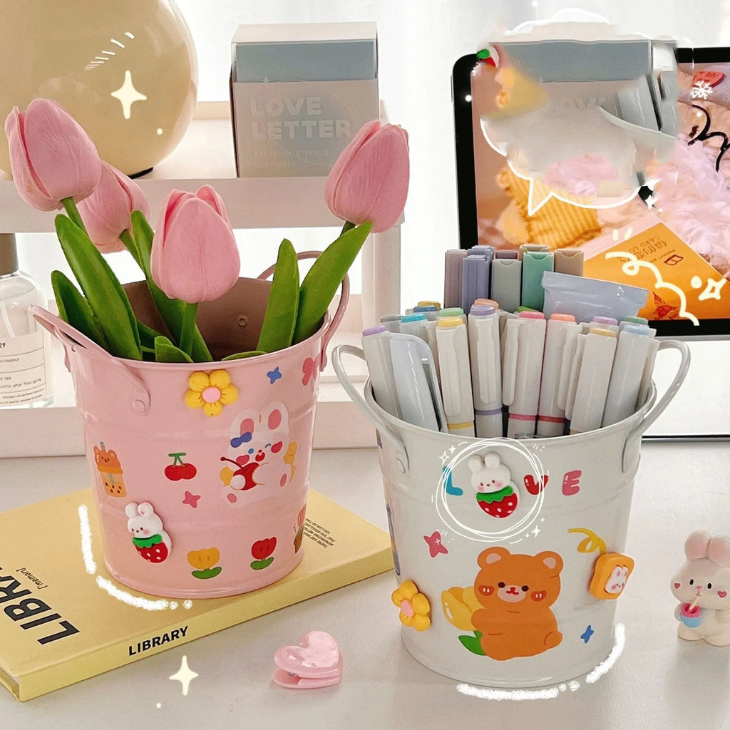 Round metal desktop pen holder storage box in a choice of colours including pink, green, red, white, and yellow.