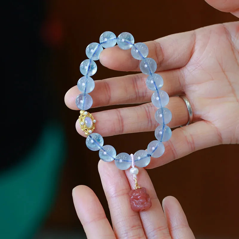 Aquamarine DIY bracelet for women with Fengjiu fox charm, showing pearl and crystal design options.