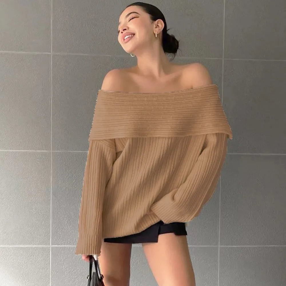 Women's loose long sleeve acrylic pullover sweater in white, shown laid flat.
