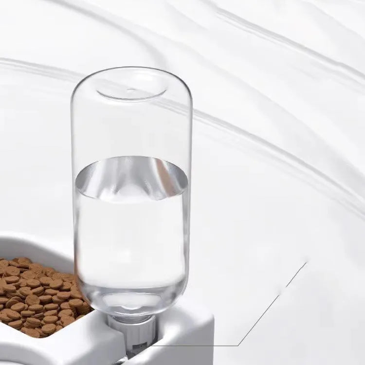 White plastic pet water fountain with electric pump on a floor.