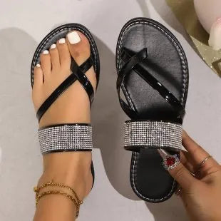 Women's beach sandals with rhinestone toe strap and flat rubber soles in black, gold, and silver colours