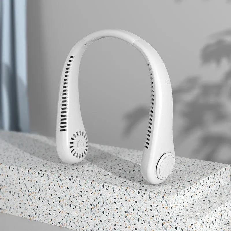 Blue portable bladeless neck fan hanging around a person's neck, showing the USB port.
