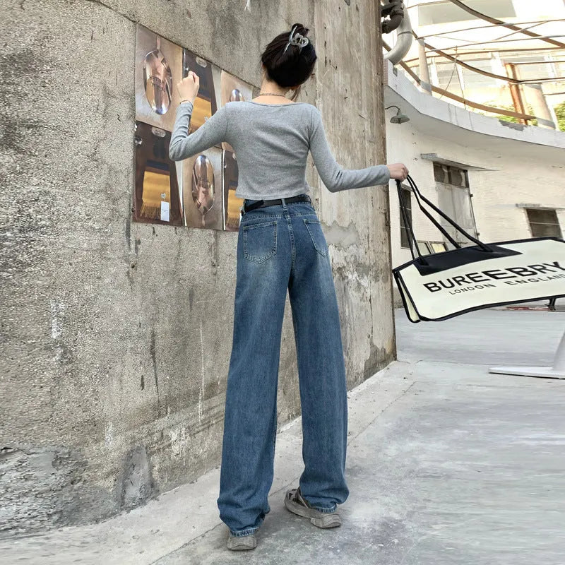 A woman wearing high-waist straight leg jeans in a retro blue colour, showcasing the classic denim fit.