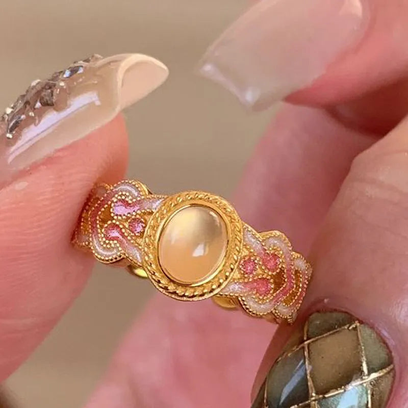 Open mouth geometric ring with pink crystal enamel accents on gold-plated copper band