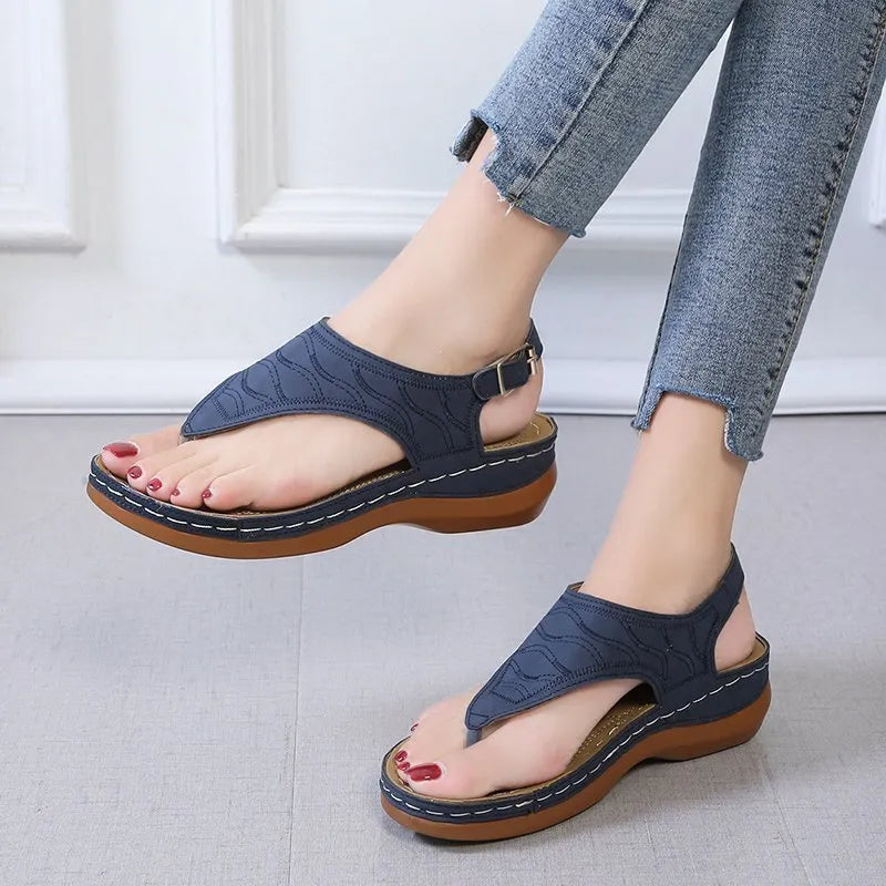 Women's wedge heel casual sandals in red with an adjustable back strap and flip-flop style.