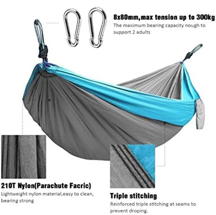 A sapphire blue double-layer nylon hammock hung between two trees, showing its full 270cm length and 140cm width.
