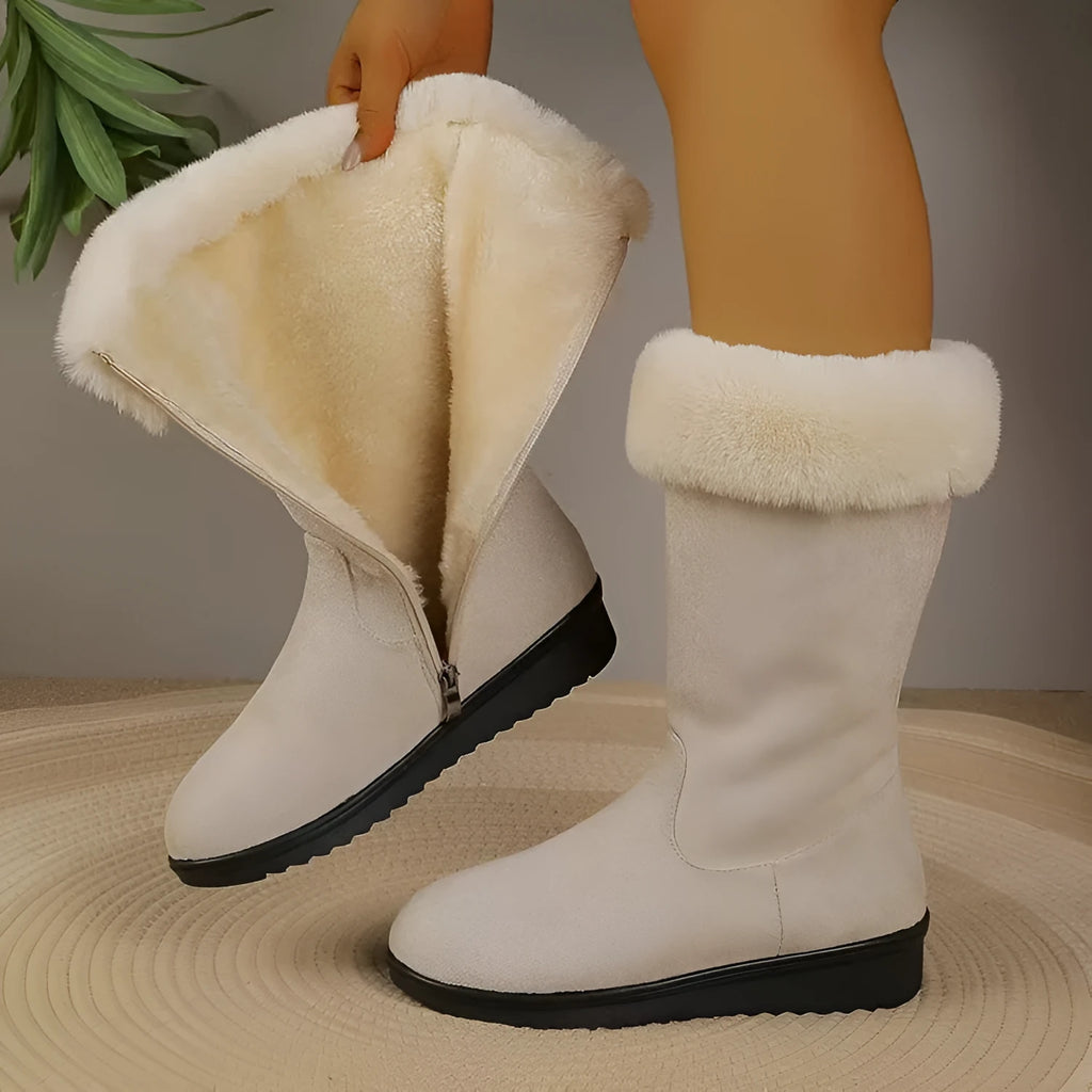 Fleece-lined mid-calf snow boots in black with waterproof platform sole and round toe, on a white background