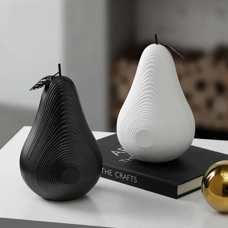 Handmade resin apple and pear decorative sculptures in various colours on a shelf