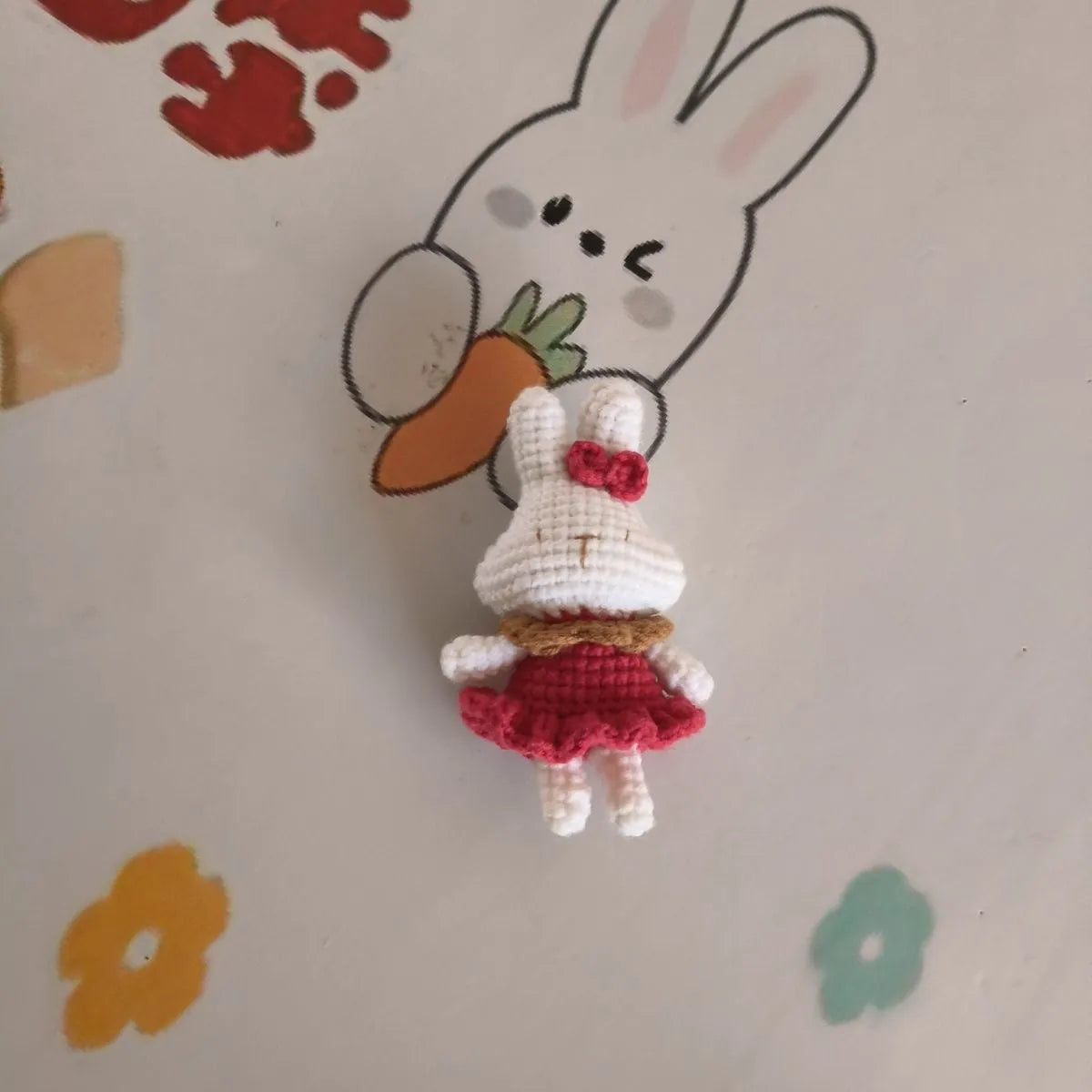 Hand-crocheted wool rabbit key chain with cute design, shown in two style options