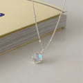 Geometric ornamental stone pendant on a silver curb chain necklace for women.